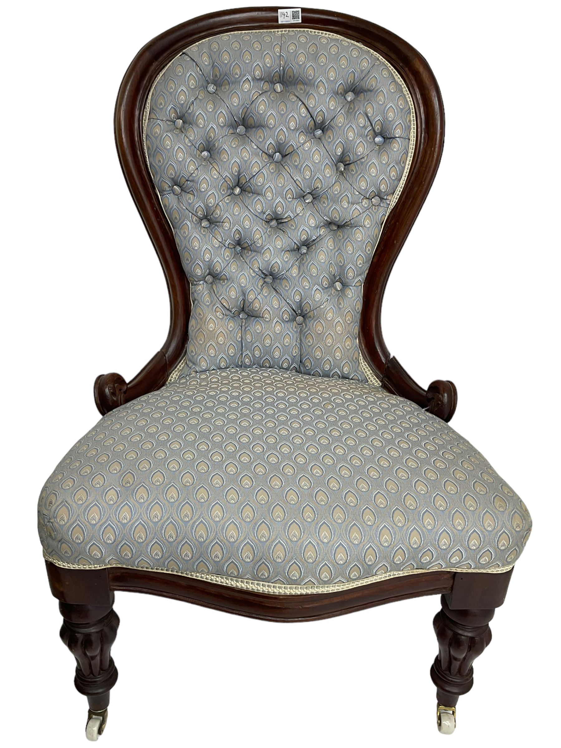 Victorian walnut framed open armchair, scrolled arm terminals over spiral turned arm supports, upholstered in foliate patterned fabric with sprung seat, on turned supports and brass castors (W65cm H92cm); and Victorian mahogany nursing chair with lobe carved supports (W60cm H92cm)