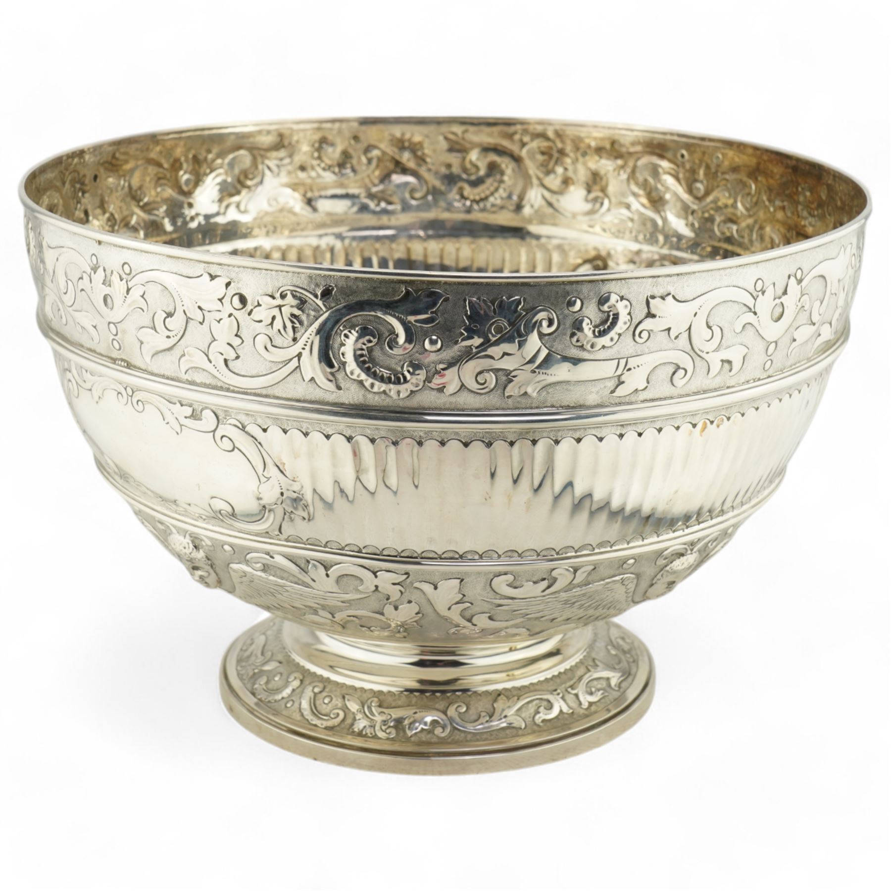 'Delwood Trophy in Memory of Col. H.H. Wilberforce' - A large Victorian silver rose bowl embossed with masks, wings, scrolls etc on a short pedestal foot D29cm London 1882 Maker Walter & John Barnard 