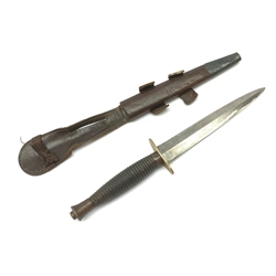 British Fairbairn-Sykes type 3rd pattern Commando fighting knife with unmarked 17cm double edged blade, oval brass cross-guard and ringed grip, in brown leather scabbard 32cm overall
