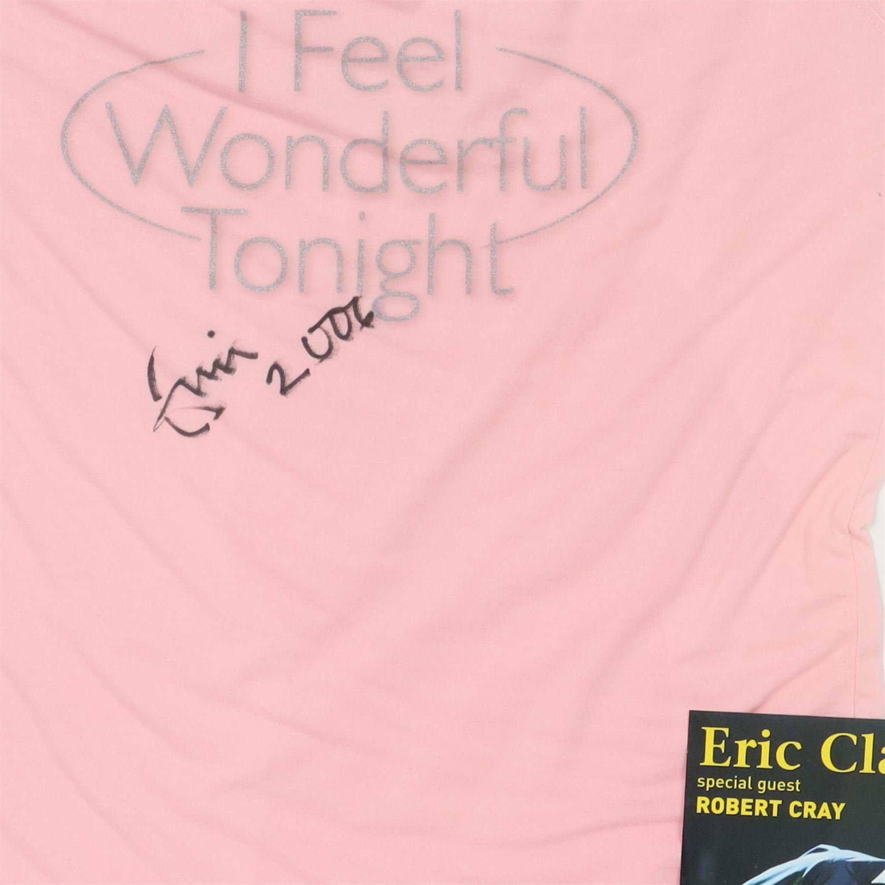 Signed Eric Clapton 2006 tour t-shirt, pink t-shirt with 'I Feel Wonderful Tonight' in silver lettering, signed by Eric Clapton in black marker to front, in framed display with ticket and programme, frame H83cm