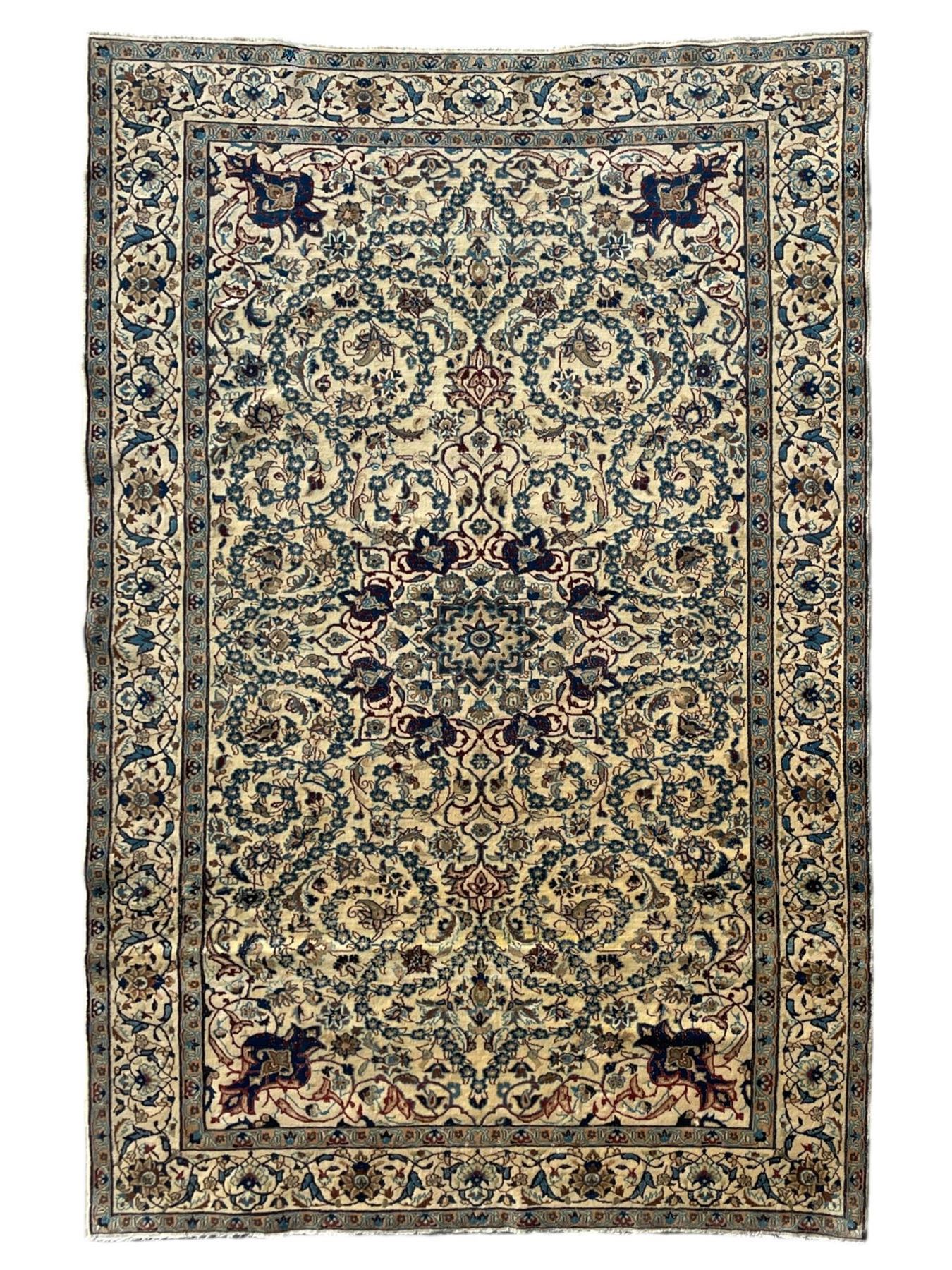 Persian Kashan ivory ground rug, wool with silk inlay, central floral rosette medallion surrounded by trailing flower heads and interlacing leafy branches, the repeating scrolling border decorated with palmettes, within guard stripes