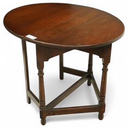 20th century oak drop-leaf table, of gateleg form with oval top, raised on turned legs and stretchers with twin gate supports