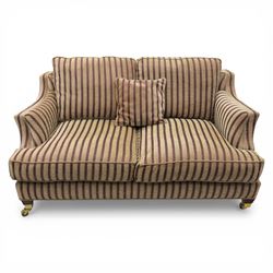 Late 20th century fabric upholstered sofa, with loose back and seat cushions, broad padded arms with piped borders, upholstered in striped textile, raised on concealed feet