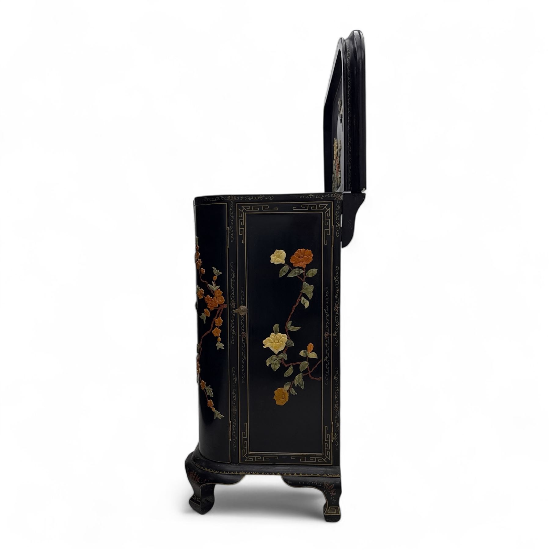 Early 20th century Chinoiserie lacquered cabinet, rounded rectangular top above a fall front enclosing fitted interior with lacquered decoration, over a pair of cupboard doors and flanked by side compartments with tiered bottle shelves, the black lacquer ground decorated throughout with raised and painted floral sprays, on shaped bracket feet