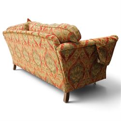 Duresta - traditional shape two-seat sofa with out-swept arms, upholstered in crimson ground fabric decorated with palmettes and foliate motifs with matching loose and scatter cushions, raised on compressed bun feet with brass cups and castors