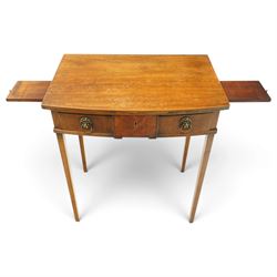 George III mahogany bowfront side table, fitted with single frieze drawer with brass lion-mask handles and twin candle-rests to each side, lower reeded edge on square tapering supports