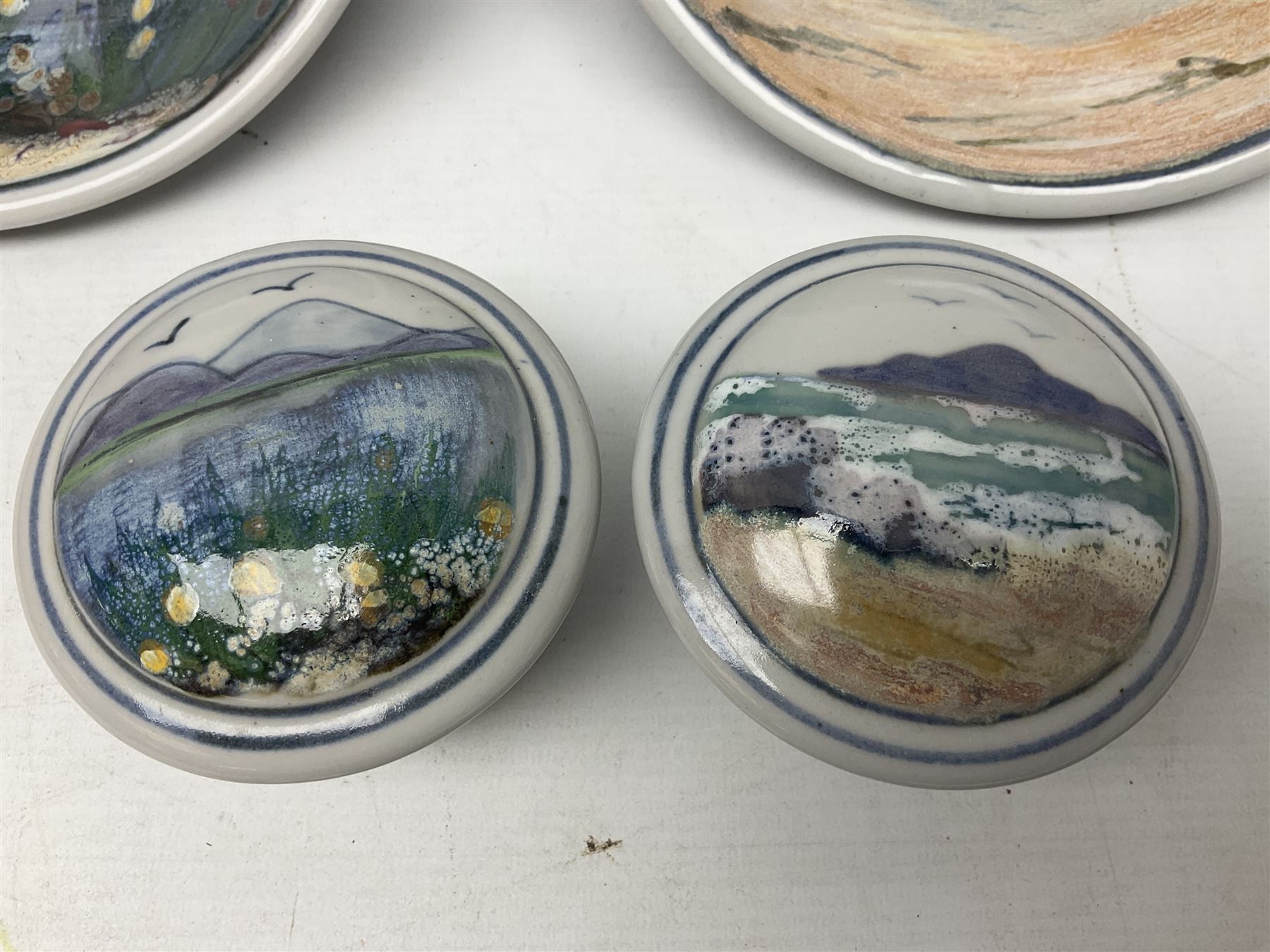 Highland Stoneware Scotland, decorated with landscapes and seascapes, comprising of two bowls, plate and two covered trinket boxes 