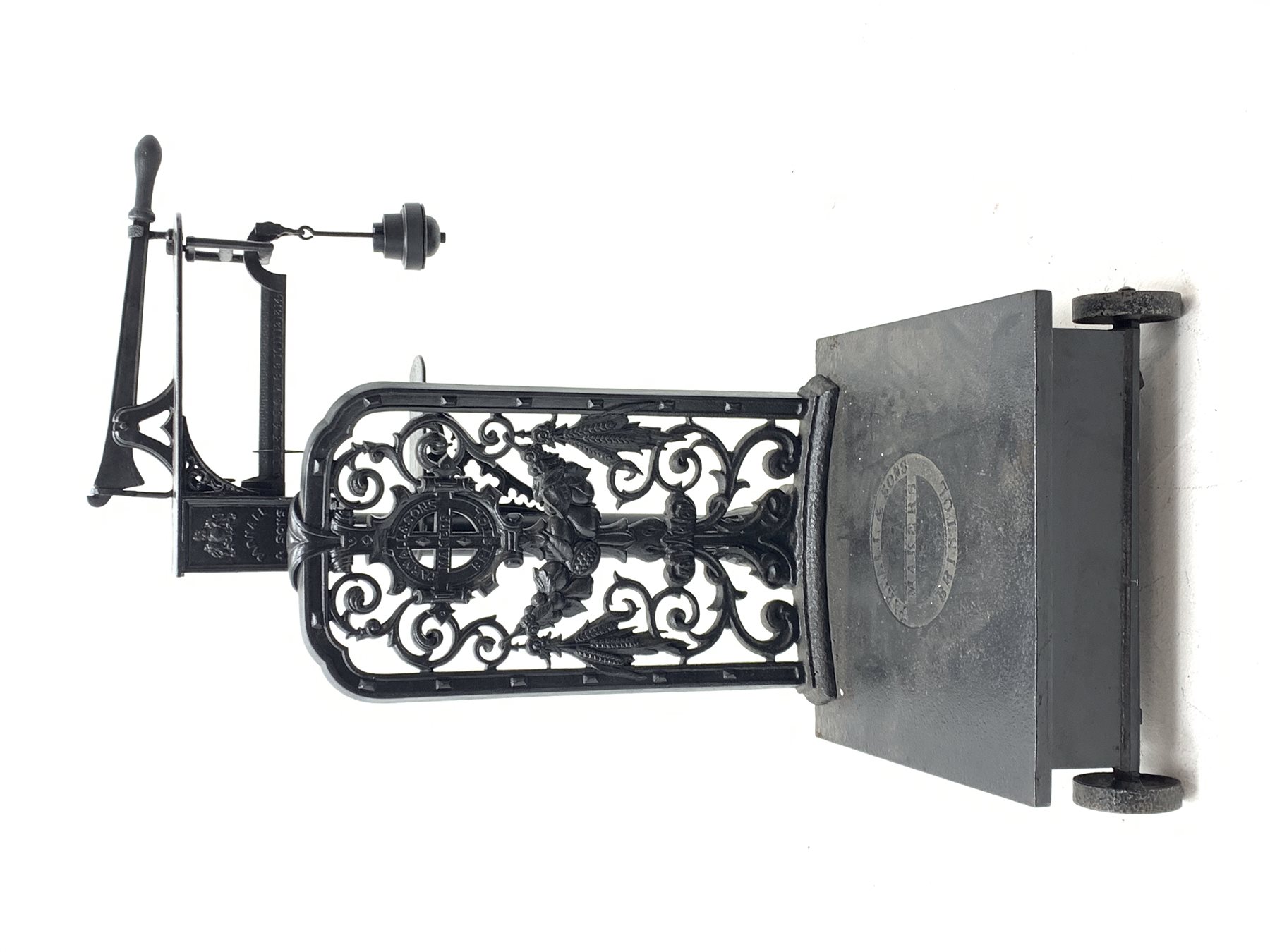 19th century platform scales by Parnall & Sons. Bristol, black painted cast iron, raised back decorated with foliage scrolls and fruit garland, H128cm