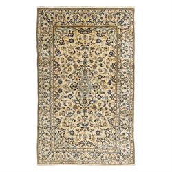 Central Persian Kashan hand-knotted carpet, ivory ground, with a central pale blue shaped ...