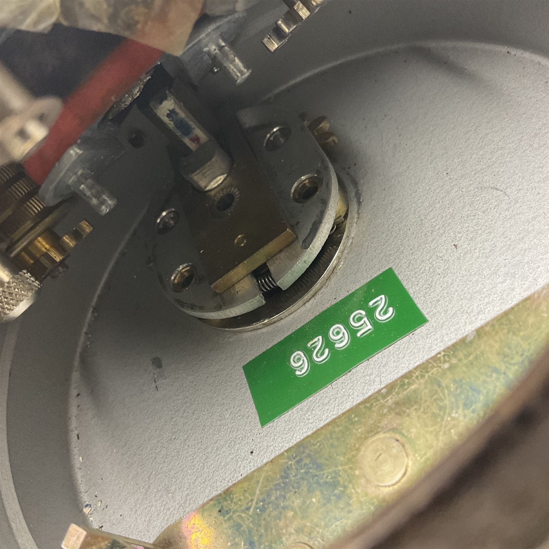 Metal cased drum shaped travelling clock with grey hammered finish, French clockwork movement and stitched leather outer case with shoulder strap; bears manuscript label 'Royal Armament Research and Development Establishment - serial no.09433' D13cm overall