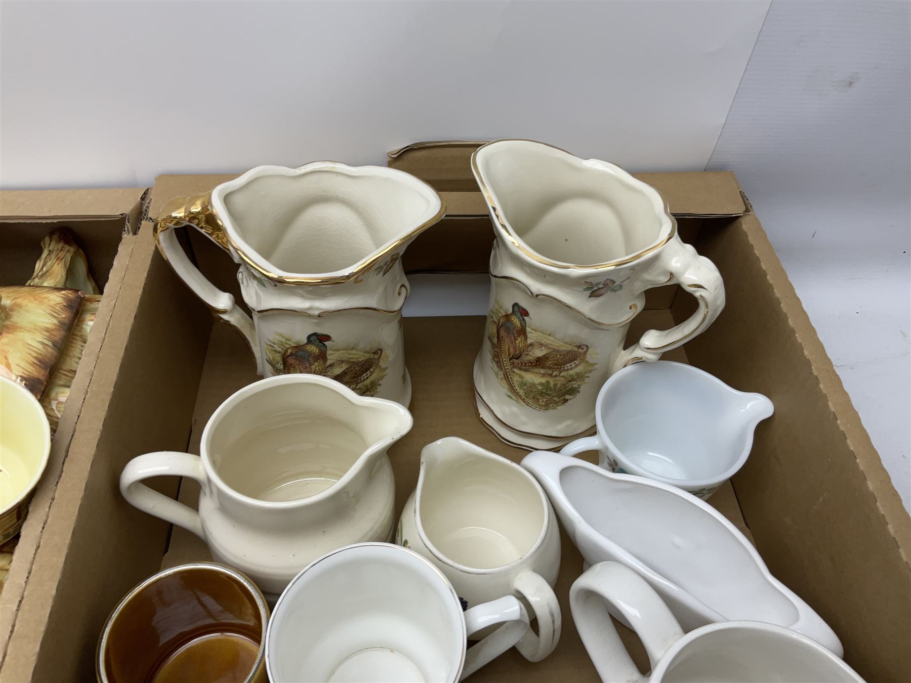 Two Poole Pottery dinner plates and a meat plate, four Copeland Spode Bermuda pattern dinner plates, Sadler jug, Keele St Pottery cottage tea wares, Torquay Motto ware, blue and white jug and bowl, two large planters and other ceramics, etc, in four boxes 