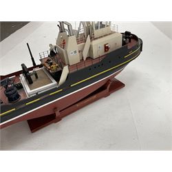 24-Volt radio controlled model of the American tug boat 'Jo-Jo' with full range of deck fittings, transmitter, remote control, receivers and two launching straps, displayed on wooden stand L103cm