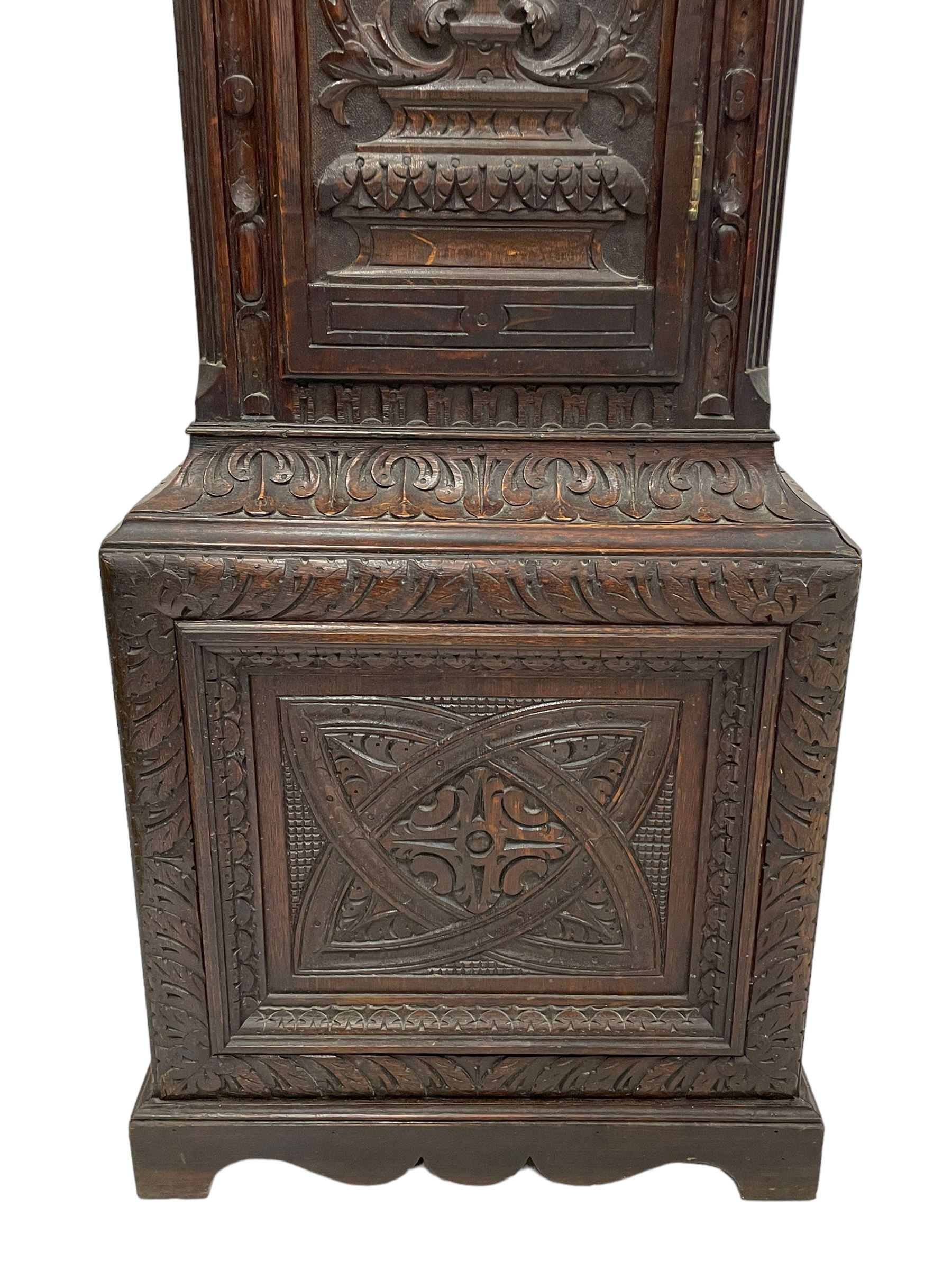18th-century profusely carved oak longcase clock - with a pagoda pediment, upstands and carving, 
 break arch hood door flanked by reeded pilasters with brass capitals, trunk with canted corners and a spire topped door, square plinth with applied skirting, break arch brass dial with wheatsheaf engraving and cast cherub and crown spandrels, engraved break arch with the London clockmakers name John Gordin, silvered chapter ring with Roman numerals, five minute Arabic's, minute and quarter hour tracks, matted dial centre with ringed winding holes, square date aperture and seconds ring, dial pinned to a five pillar movement with inside countwheel striking, striking the hours on a cast bell. With weights and pendulum. John Gordin, is possibly a mis-spelling or phonetic spelling of John Gordon, of London, who worked from Ludgate Street in the parish of St. Gregory by St. Pauls. Apprenticed in 1689 and died in 1732 when his will was proven.
