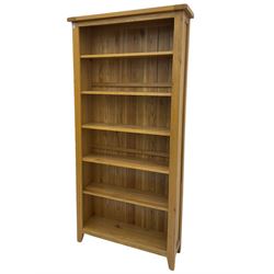 Tall light oak bookcase, fitted with five shelves