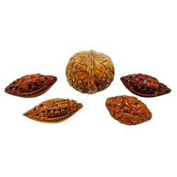 Japanese Meiji walnut shell carved with 'Thousand Faces' W4.5cm, Japanese carved walnut Ojime and three others, L4.5cm max (5) Provenance: private collection   