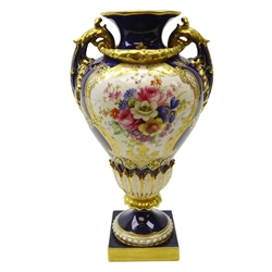  Early 20th century Royal Worcester two handled pedestal vase, hand painted with floral sprays by E. Phillips with relief moulded decoration and raised gilding on a square base, c1911, shape no. 1937, H19.5cm.  Provenance Property of Bob Heath, Brandesburton Formerly of Ravenfield Hall Farm near Rotherham  