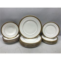 Royal Doulton Royal Gold pattern tea and dinner service for eight, comprising dinner plates, side plates, tea plates, soup bowls, sauce boat and saucer, dessert bowls, coffee cans and saucers, teacups and saucers and two lidded tureens