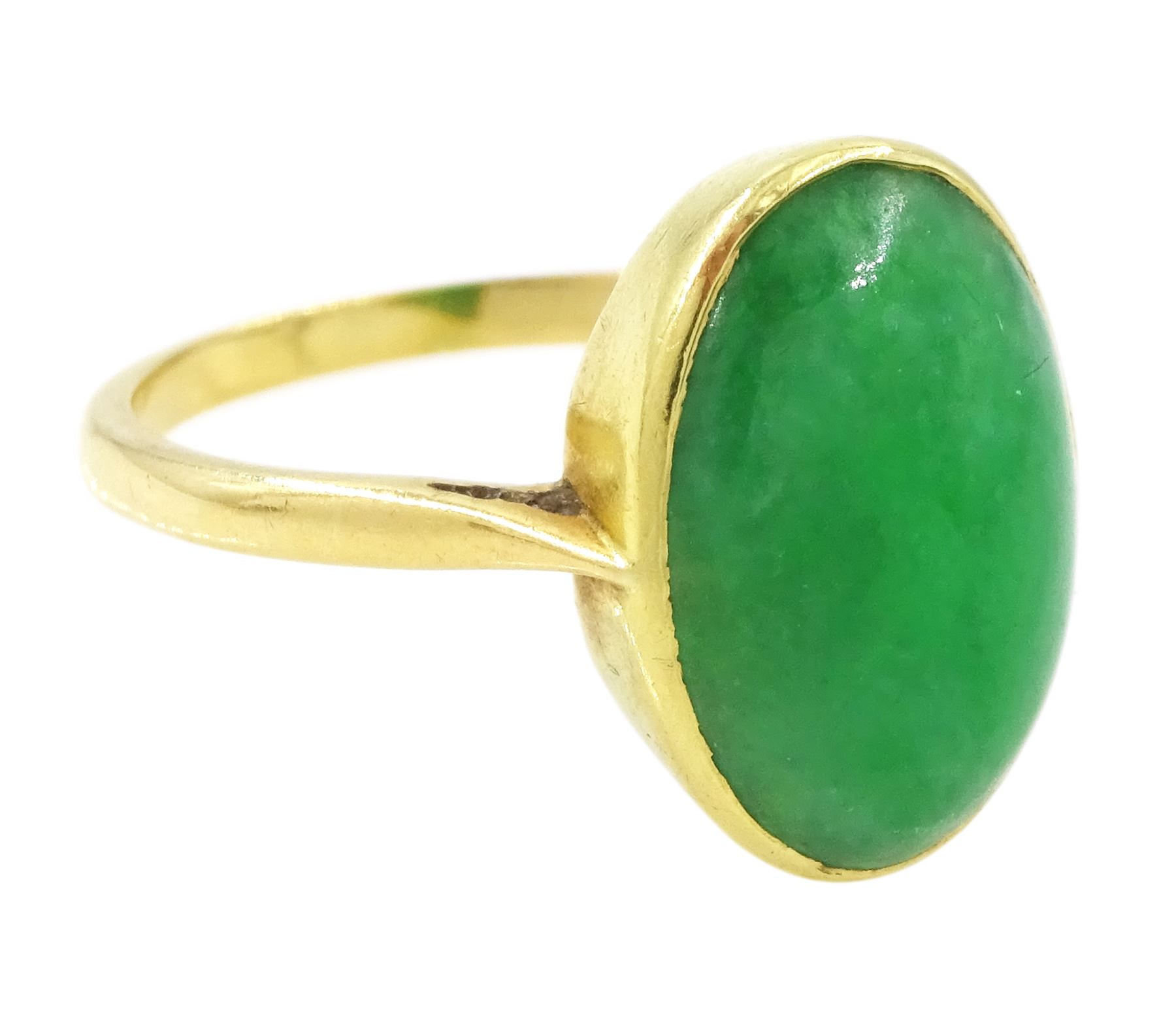 Early - mid 20th century gold jade ring, bezel set with a single oval cabochon jade of approx 4.10 carat, stamped 18ct