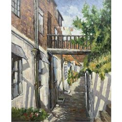 Donald Gray Midgely (British 1918-1995): Street in Robin Hood's Bay, oil on board signed and dated '75, 55cm x 45cm