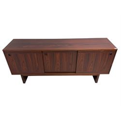 NH Chapman & Co Siesta - mid-20th century sideboard, fitted with three sliding doors, enclosing two drawers and shelves, raised on twin end supports