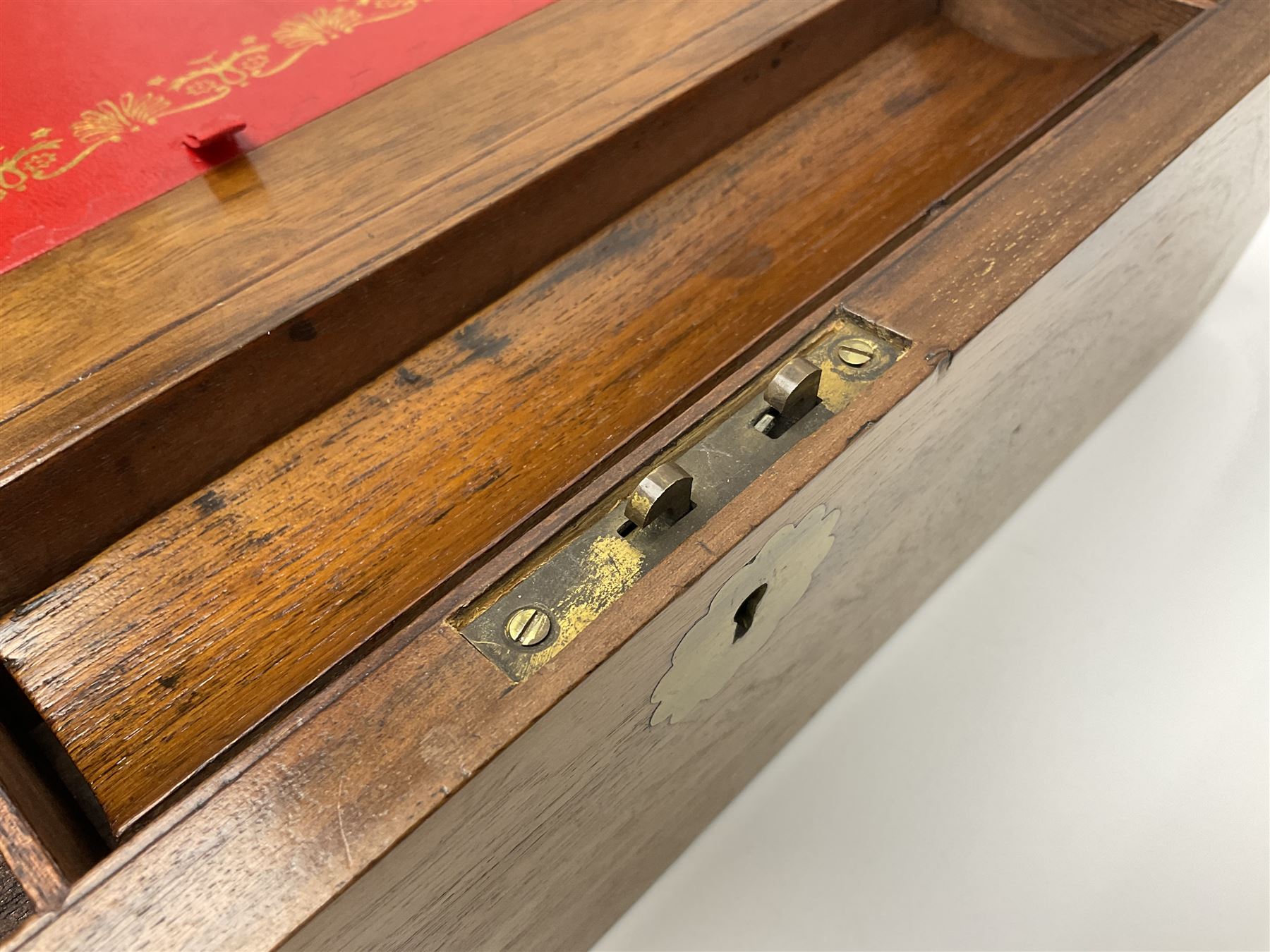 19th century burr yew wood tea caddy, of sarcophagus form, with strung details and brass mounts, the interior split into three compartments, upon four brass bun feet, together with an oak and brass bound writing slope, with red leather interior with gilt detailing, largest H16cm, W40cm