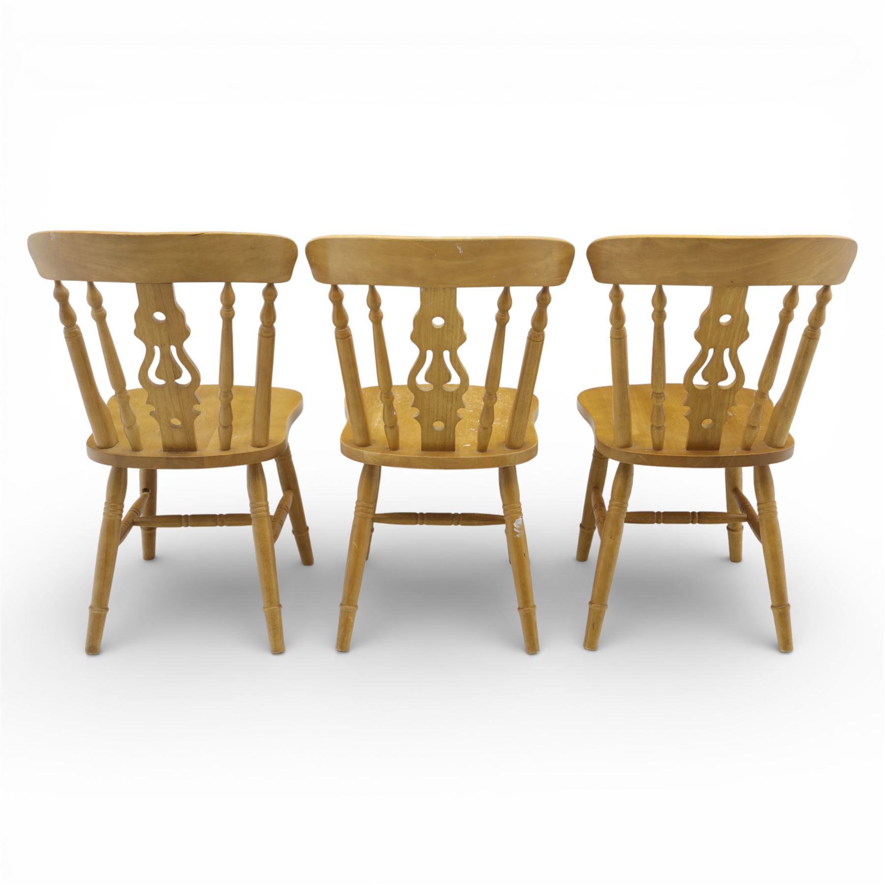 Solid oak dining table and set of seven pine farmhouse chairs including two carvers, rectangular top with tongue and groove style finish, supported a 'H' stretcher with square chamfered legs, pine farmhouse chairs with central splat and turned legs