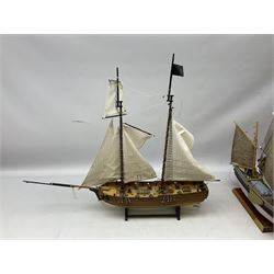 Eight model ships or boats including fishing boat with fish, nets and buoyancy aid, two mast sailing ship complete with cannons, two mast yacht with detailed rigging and life boat etc, the largest L72cm, H60cm