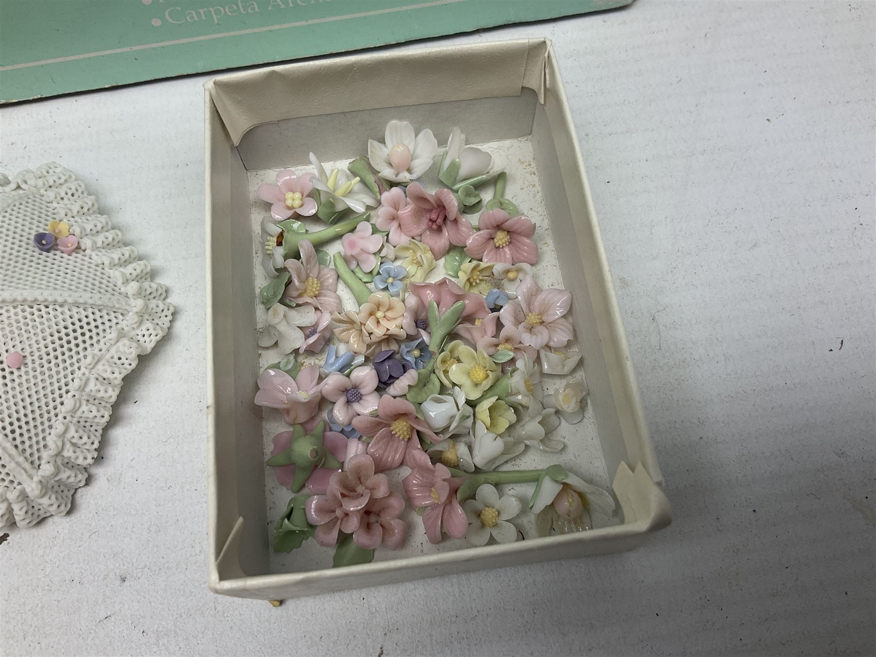 Seven Lladro flowers, comprising Japanese Camelia on base no 5181, Yellow Begonia on base no 5186, Miniature Begonia on base no 5188, Chrysanthemum on base no 5189, California Poppy no 5190.B, Miniature Begonia 5188.B and White Carnation no 5184.B, together with Lladro Spanish Joining pack with 17616 Winter Bell, Additional Lladro parasols and flowers etc 