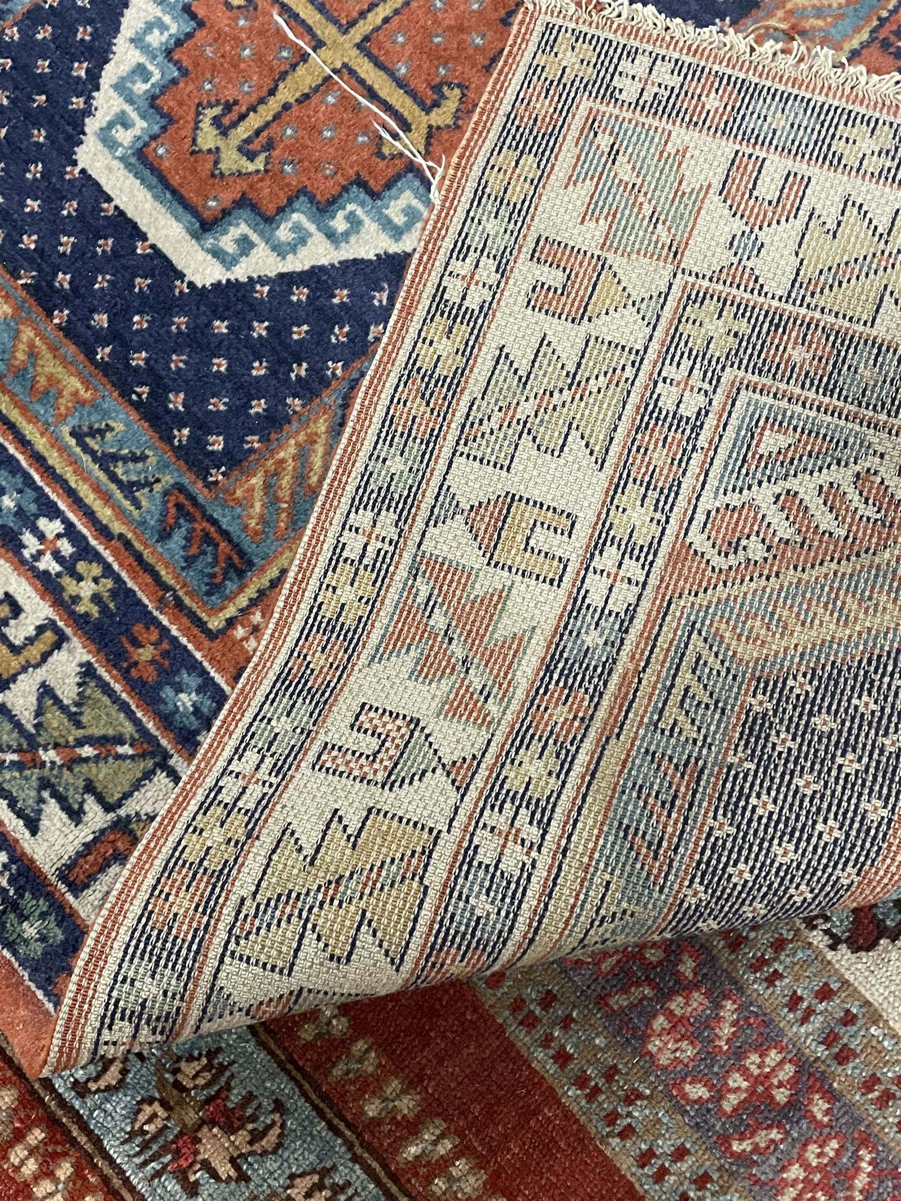 Persian red ground prayer rug, decorated with stylised flowers (201cm x 143cm), and a small Persian design triple medallion rug (142cm x 68cm)