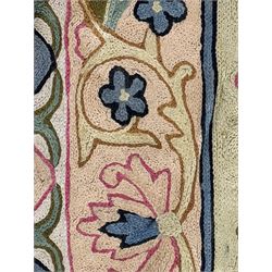 Small pastel prayer rug, cream field with Mihrab arch and trailing floral motifs in pink, blue, and green, bordered by floral patterns, knotted fringe to both ends