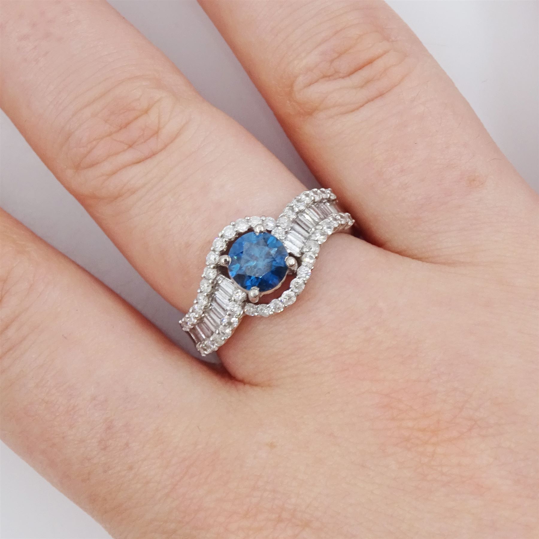 18ct white gold diamond crossover ring, the principal round brilliant cut fancy blue diamond of approx 0.75 carat, with round brilliant cut diamond surround and shoulders, stamped 750, total white diamond weight approx 0.60 carat