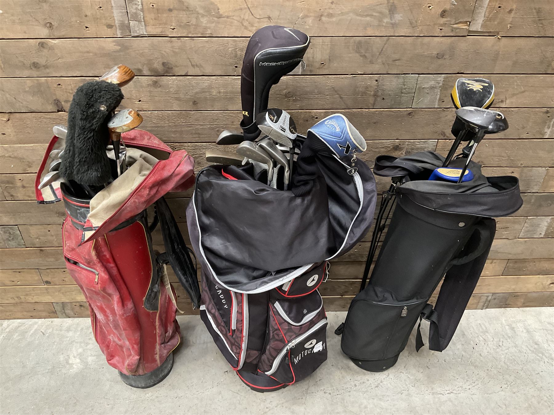 Various golf clubs in three bags