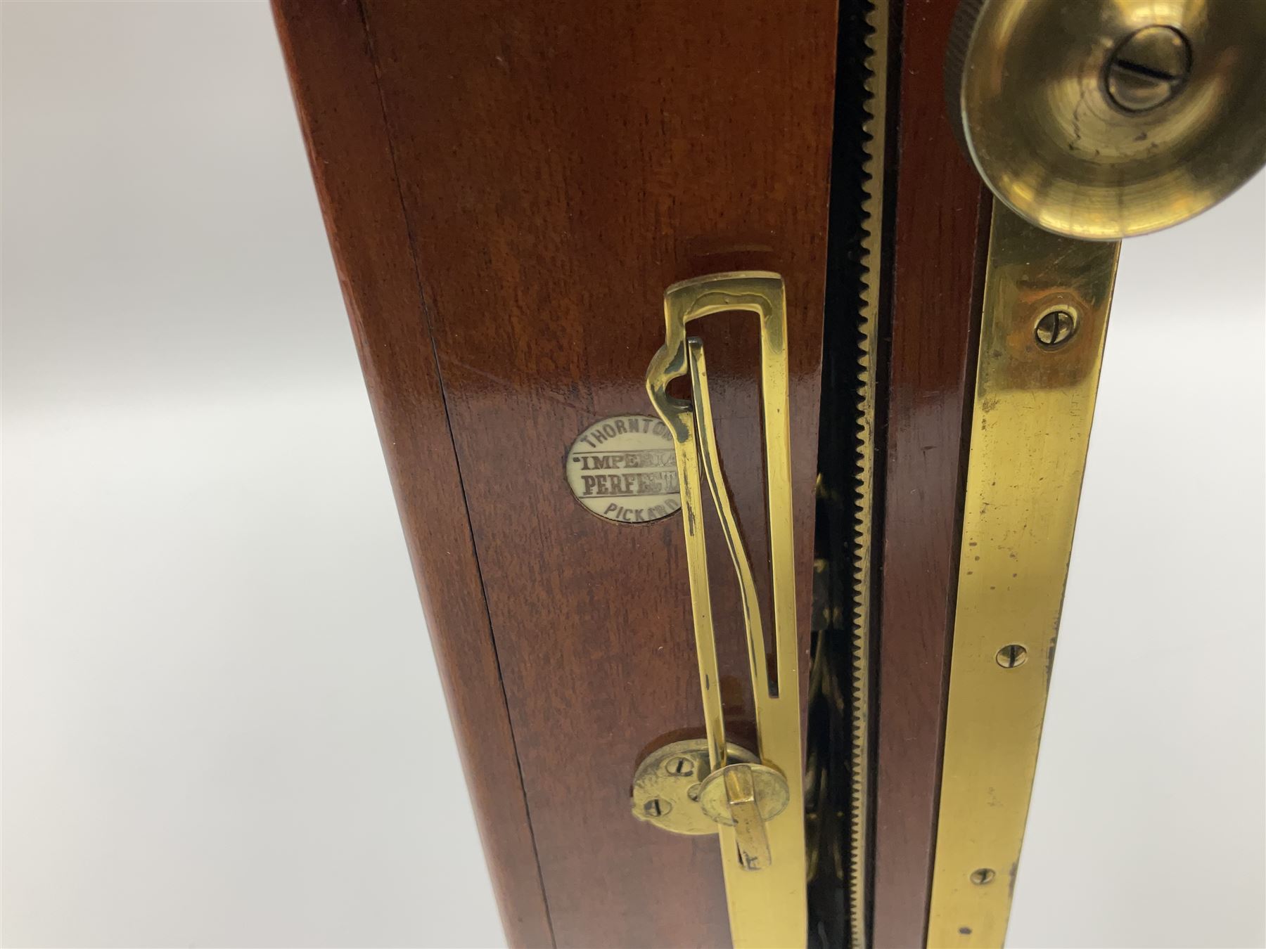 Thornton Pickard folding plate camera in mahogany and lacquered brass, no.529946 and no.529947, field model with canvas wrapped box, three mahogany photographic plates, 'Busch's Portrait Aplanat No4 Foc.14inc' lens and a wooden tripod