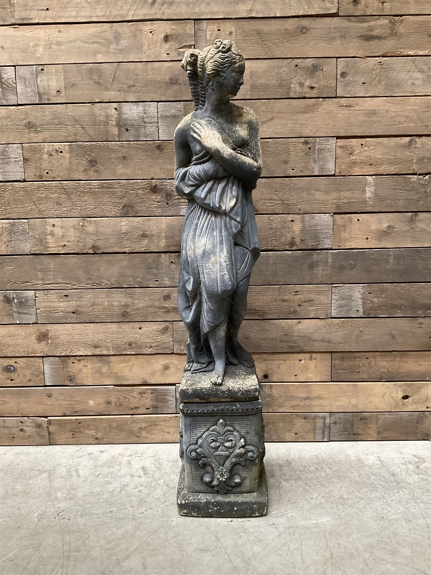 Cast stone weathered garden statue of Venus on pedestal