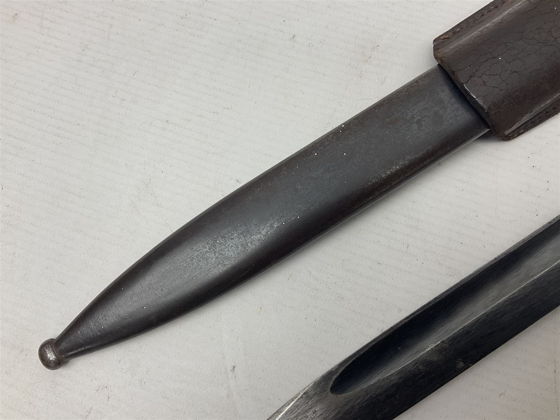 WWII German K98 Mauser bayonet by E. & F. Horster, the 24.5cm fullered blade marked 43aSW for 1943, numerous inspection marks to blade and pommel, bakelite grips and bluing to metal parts; in steel scabbard with corresponding numbers and leather frog L42cm overall