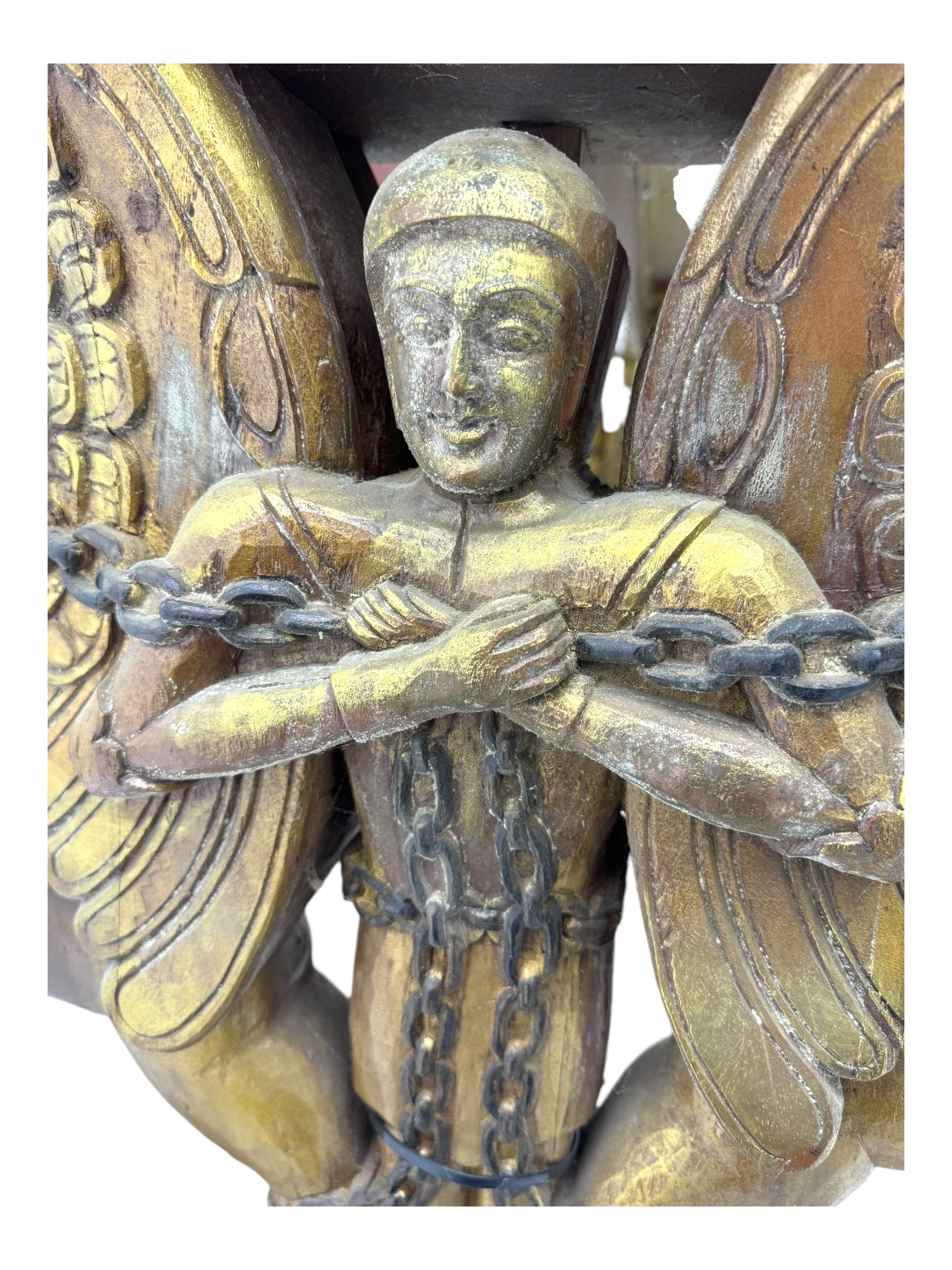 19th century Renaissance Revival carved and giltwood centre table, the rectangular top with gadrooned edge and carved frieze of repeating arched motifs with stylised scrolls, supported by a pair of carved winged griffin supports restrained by a central chained figure, on stepped rectangular bases united by carved stretcher