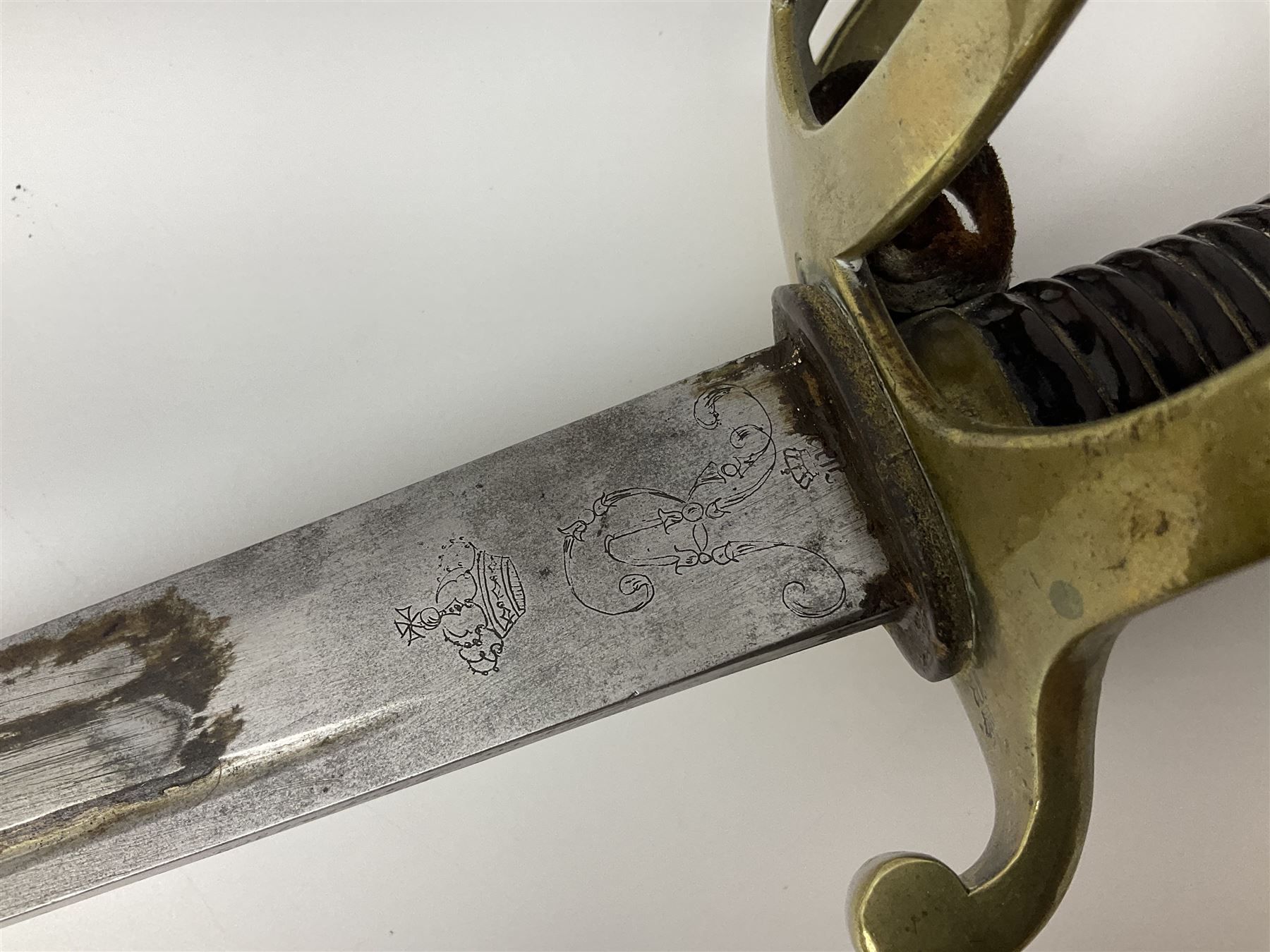 19th Century German (Saxony) Cavalry Sword, the 90.5cm single edge curved steel blade with narrow fuller to the back edge at each side, engraved with a crowned AR monogram and coat of arms, stamped with crowned AR, the back edge engraved C.v Keller im Solingen 1862, the brass half basket hilt with three flat curved bars, applied badge missing, marked G.R. 4, with ribbed leather covered grip and leather finger strap; in steel scabbard with two fixed suspension rings to one side and stamped G.R. II 118; L109.5cm overall