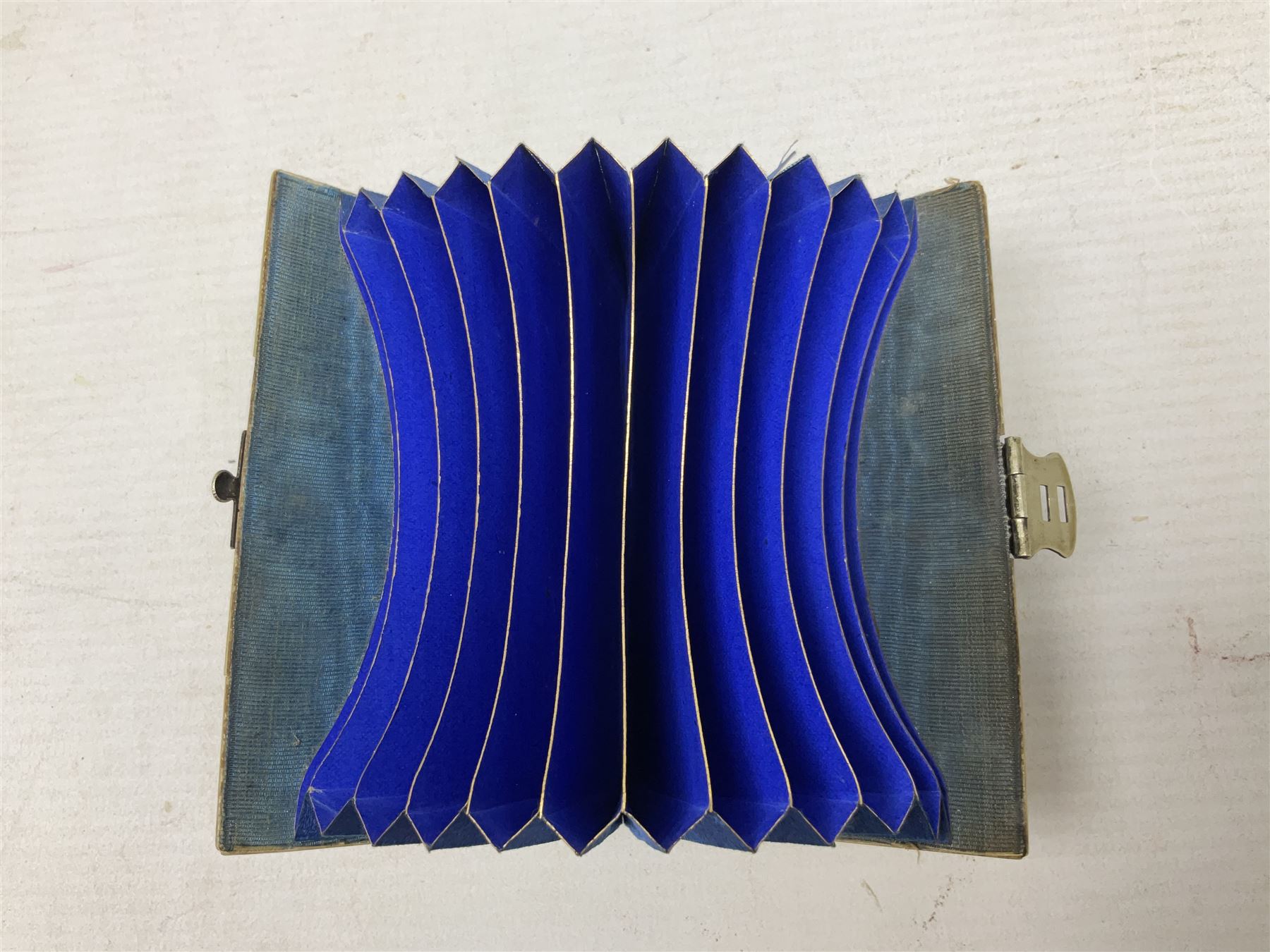 Mother of pearl and abalone inlaid card case, with central diamond shaped panel engraved with foliate decoration, together with a simulated mother of pearl card case of book form with green sun rays to cover, and simulated wood effect cigarette case with hinged lid with diamante style banding, largest L10cm