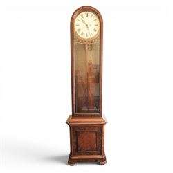 Late 19th century Vienna walnut regulator wall clock, arched glazed case with moulded cornice and figured walnut veneers, circular enamel dial with Roman numerals and pierced hands, carved foliate fretwork beneath the dial, single pendulum movement with brass weights and glazed lower section
