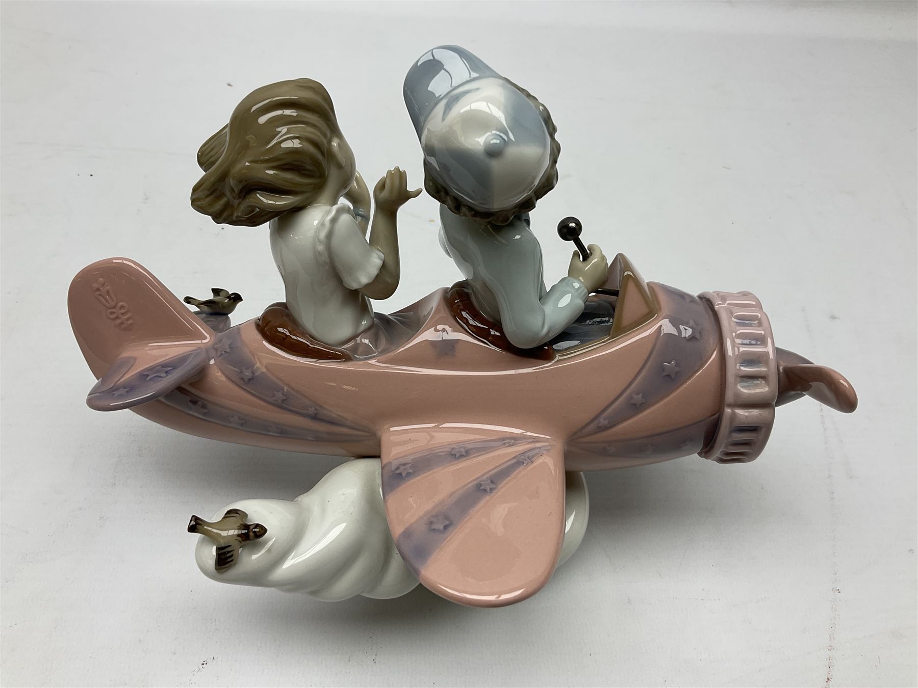 Lladro figure, Don't Look Down, modelled as a girl and boy in a plane, sculpted by Joan Coderch, no 5698, year issued 1990, year retired 2004, H17cm