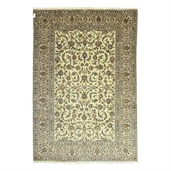 Central Persian Kashan carpet, ivory ground, field with an all-over design of scrolling pa...
