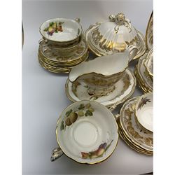 Extensive Spode dinner and tea service, decorated in the Golden Valley pattern, comprising eighteen dinner plates, ten salad plates, ten side plates, ten twin handled soup bowls and ten saucers, ten bowls, two sauce boats and two stands, two square serving dishes, smaller oval serving dish, two tureens and covers, two large oval serving platters, one smaller example, teapot, coffee pot, milk jug, twin handled lidded sucrier, and ten teacups and ten saucers, with red printed marks beneath 