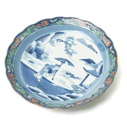 Japanese 19th century Arita style dish, painted centrally in blue and white with a lady carrying peaches, marked in blue to base, W28.5cm 