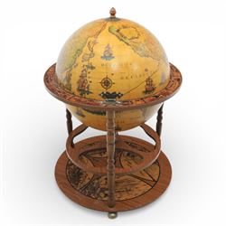 Late 20th century drinks globe, with lift off top with rotating inside with apertures for bottles, raised on brass castors