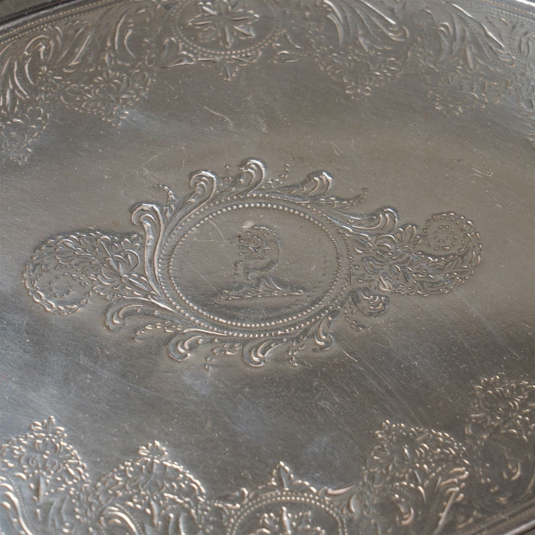George III Irish silver oval teapot stand engraved with garlands scrolls and central crest on shaped supports L20cm Dublin 1802 Maker possibly Richard Sawyer