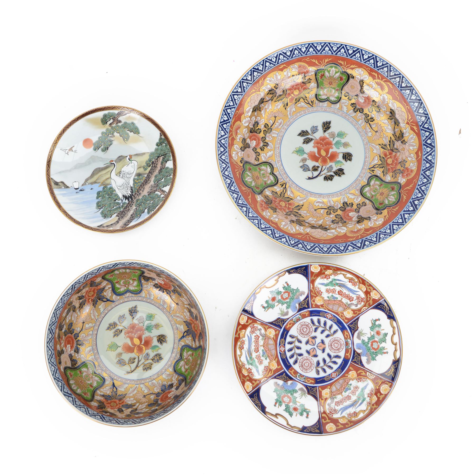 Japanese Imari Arita charger, with floral decoration highlighted in gilt, together with a similar bowl, smaller Arita charger and a plate decorated with cranes in a lake landscape, charger D37cm