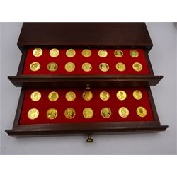 Danbury Mint, Our Royal Sovereigns Collection, seventy 22 carat gold plated silver medallions depicting the complete line of British monarchs to mark the 1200th anniversary of the first coronation, contained within wooden table top collectors cabinet with two drawers, with certificate of authenticity, with two drawers, hallmarked Danbury Mint, London various dates