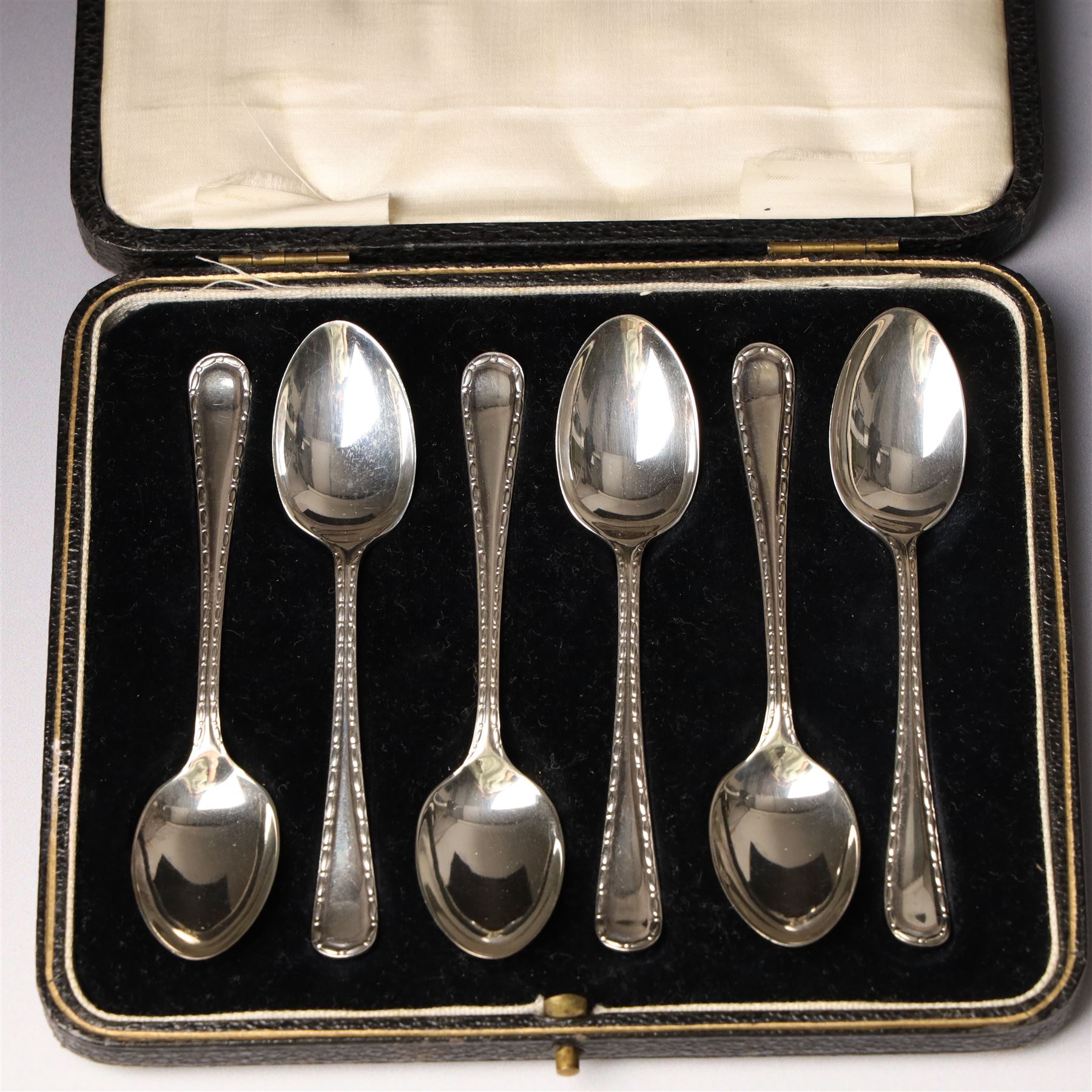 Set of six silver coffee spoons Birmingham 1933 , another set with bright cut stems and set of six silver handled pastry knives, all cased