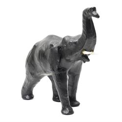 In the style of Liberty & Co - pair of 20th century ebonised papier mache elephants 