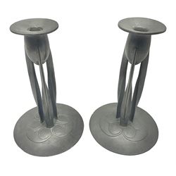 Pair of Solkets English pewter candlesticks, the bud shaped sockets raised upon three angular fin supports and a slightly domed circular base with cast stylised foliate decoration, H23cm